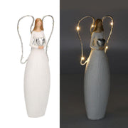 Angelo resina bianco con led e cuore cm10x5h24